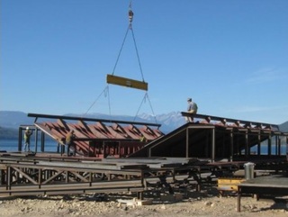 Lower side-shells being fitted onto keel module. midship-section-takes-shape.jpg Bulkheads that form part of the engineering deck. Engineering deck floor being lowered into place. midship-section-takes-shape7.jpg Transverse watertight bulkhead being fit-up. Starting to have a boat-like shape!